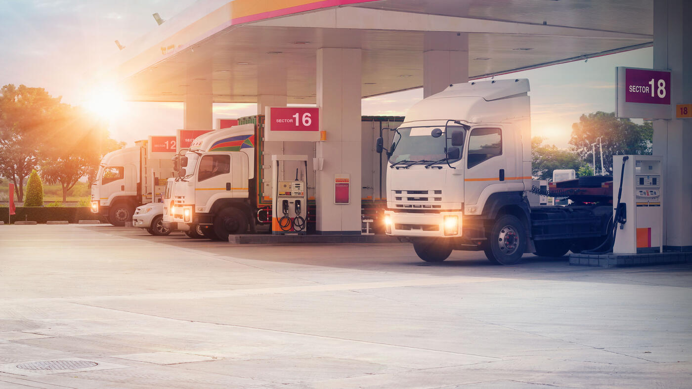 photo of a gas station with trucks fueling