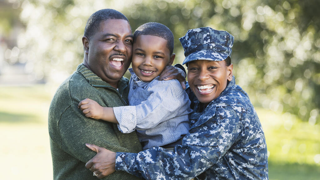 black military family embracing smiling