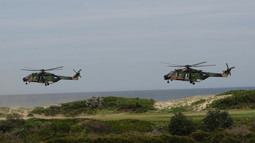 Camouflaged Army Blackhawk helicopters involved in training exercises.