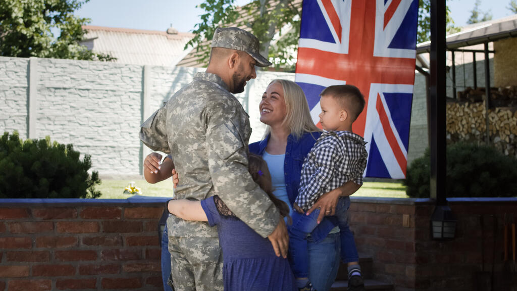 Loving family meeting soldier back at home